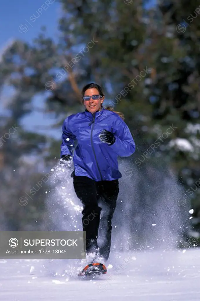 A woman running on snowshoes in Lake Tahoe, California