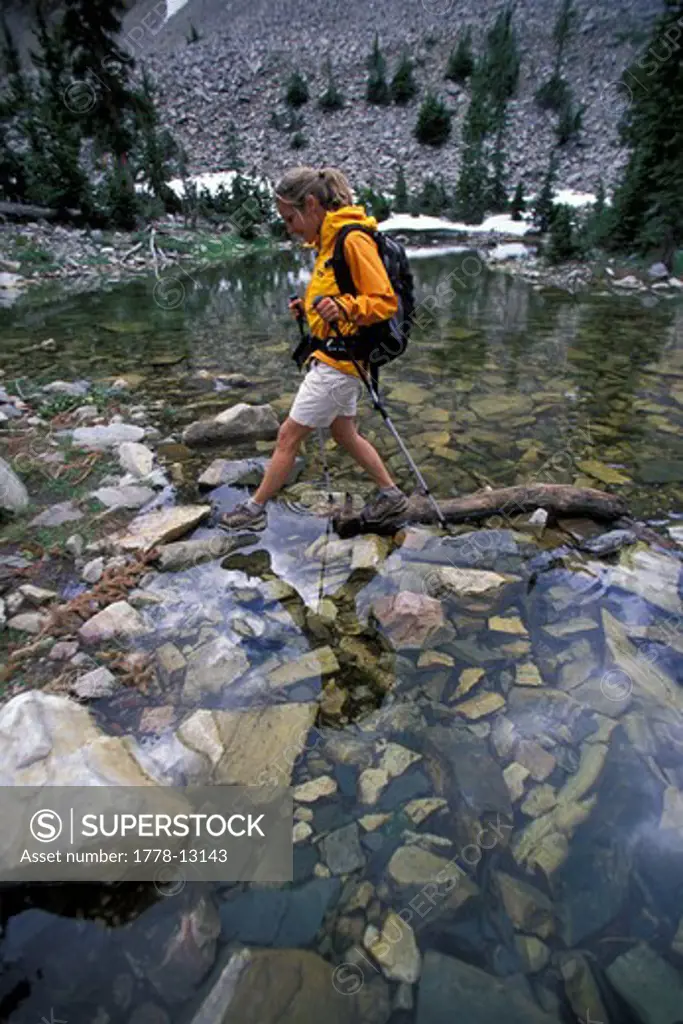 A woman crosses a stream in Great Basin NP in Nevada