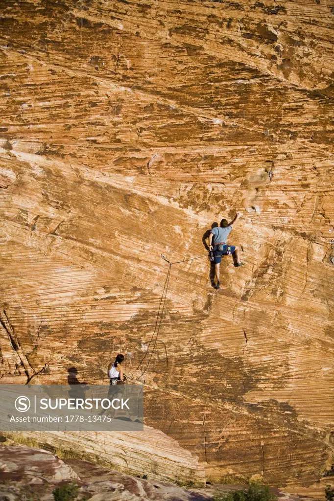 A couple climbing at the sandstone wall of Calico Basin, in Red Rocks Canyon Conservation Area
