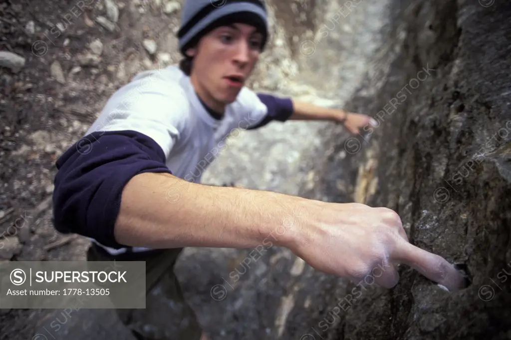Climber using a finger hold while bouldering near Austin, Texas