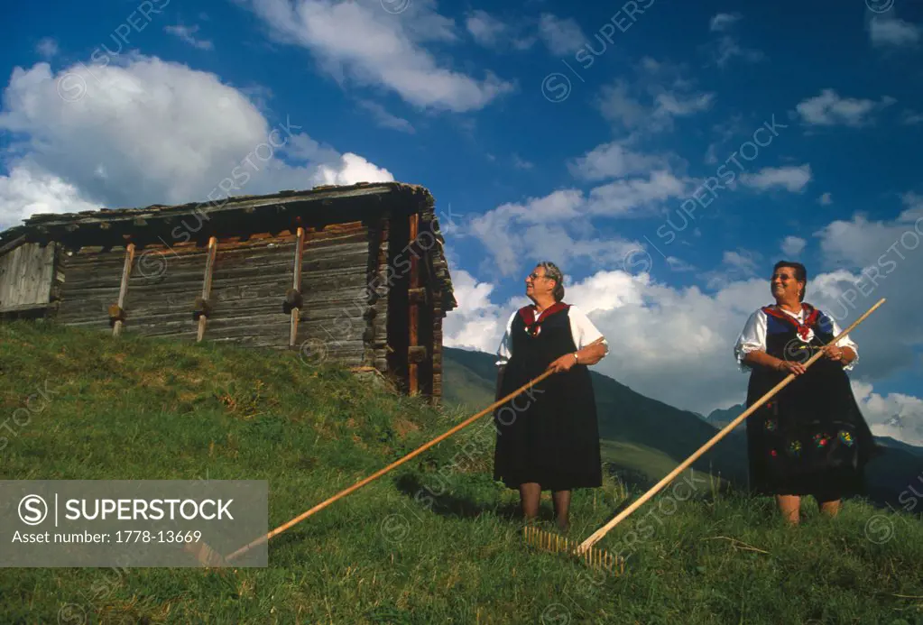 Two people in traditional Swiss costumes in Val d'Herens, Switzerland