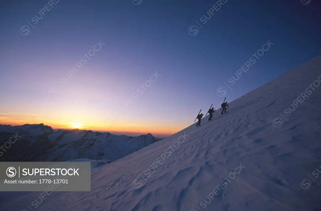 Ski-mountaineers on the side of a mountain