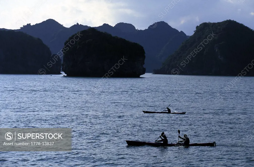 Racers paddling sea kayaks in Halong Bay during an adventure race in northern Vietnam (Silhouette)