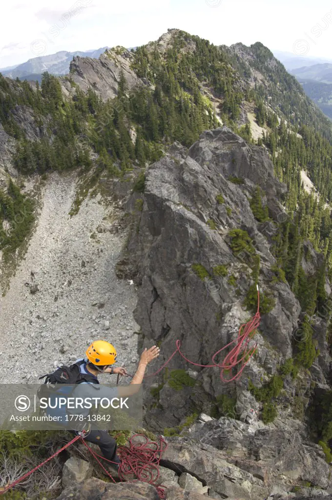 Climber tosses rope off an edge in Washington