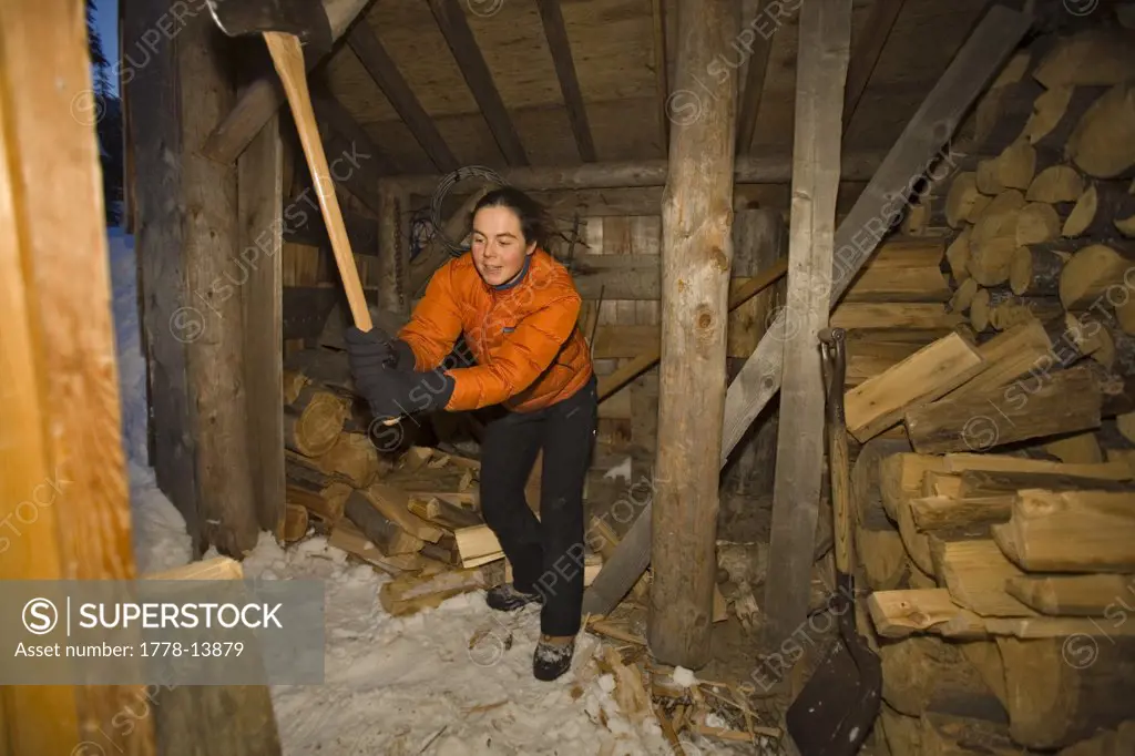 woman chopping wood, Canada