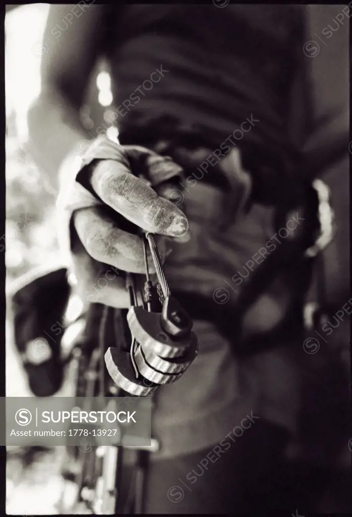 A close up view of a rockclimber's hand holding a camming device, Paradise Forks, Arizona
