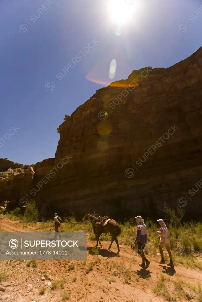 Adventure racers leading a horse and hiking in a race in Moab, Utah