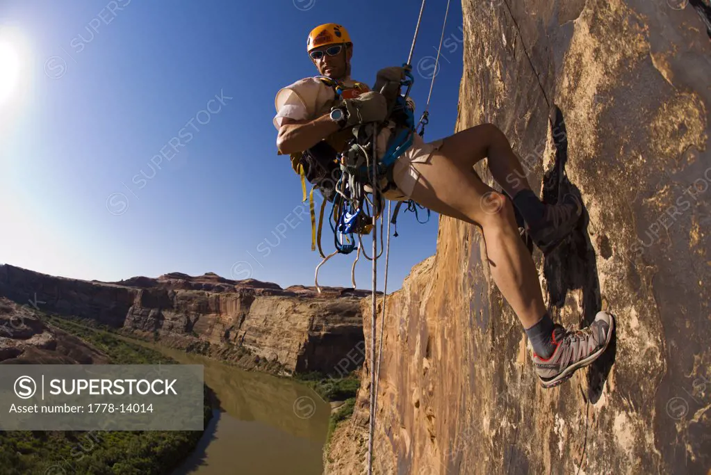 Adventure racer rappelling over a river in a race in Moab, Utah