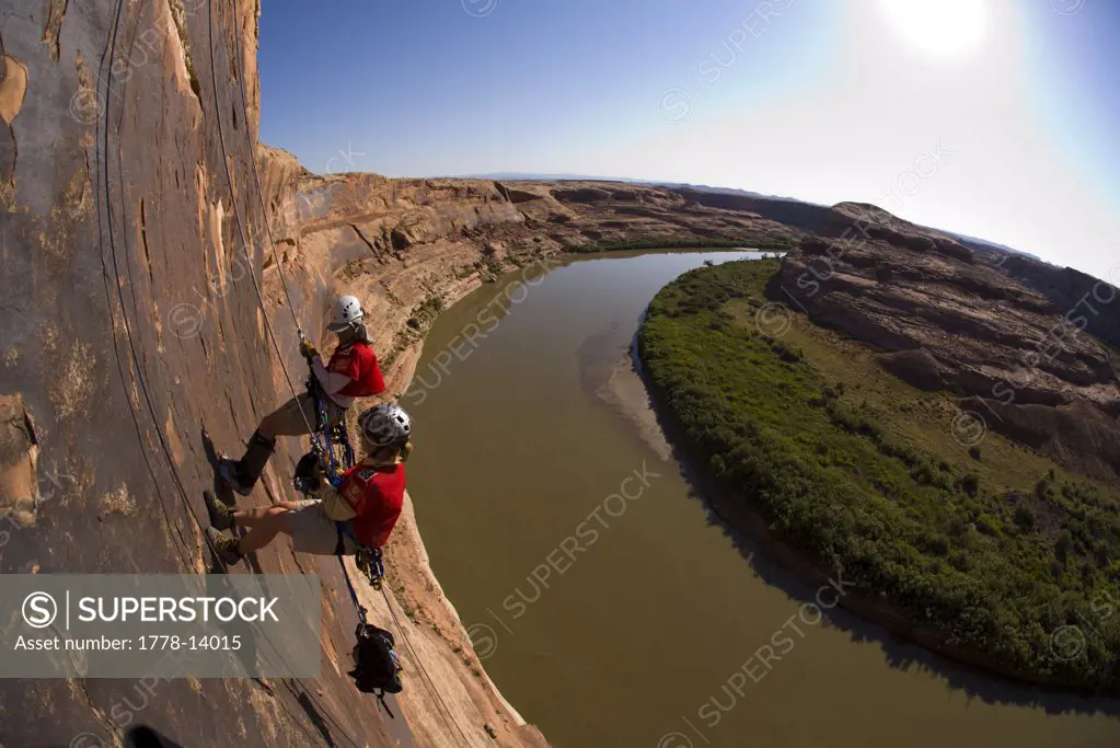 Adventure racers rappelling over a river in a race in Moab, Utah