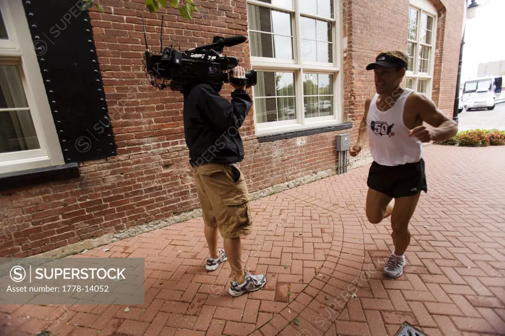 Runner being videotaped while running a marathon in Wichita, Kansas