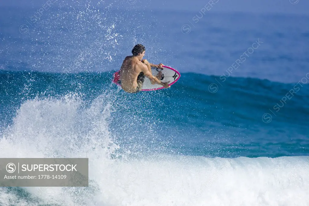surfer captured during an ariel manouver in Hawaii