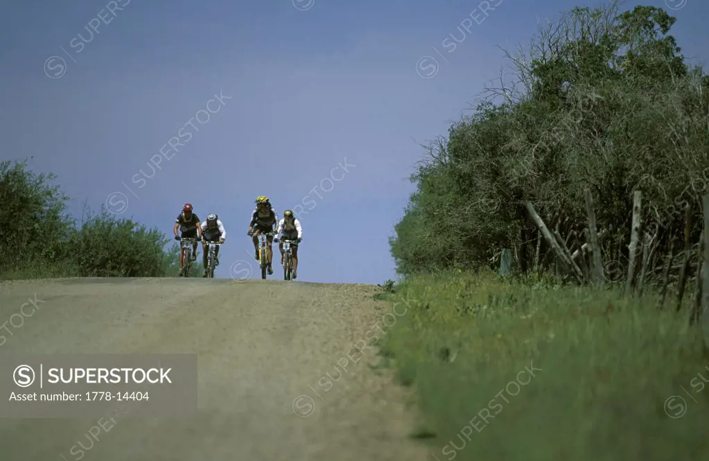 Team mountain biking on a dirt road in an adventure race in Telluride, Colorado