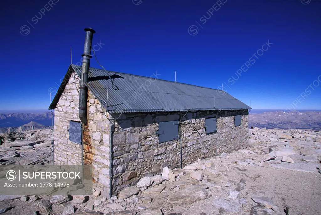 Stone cabin on top of a mountain