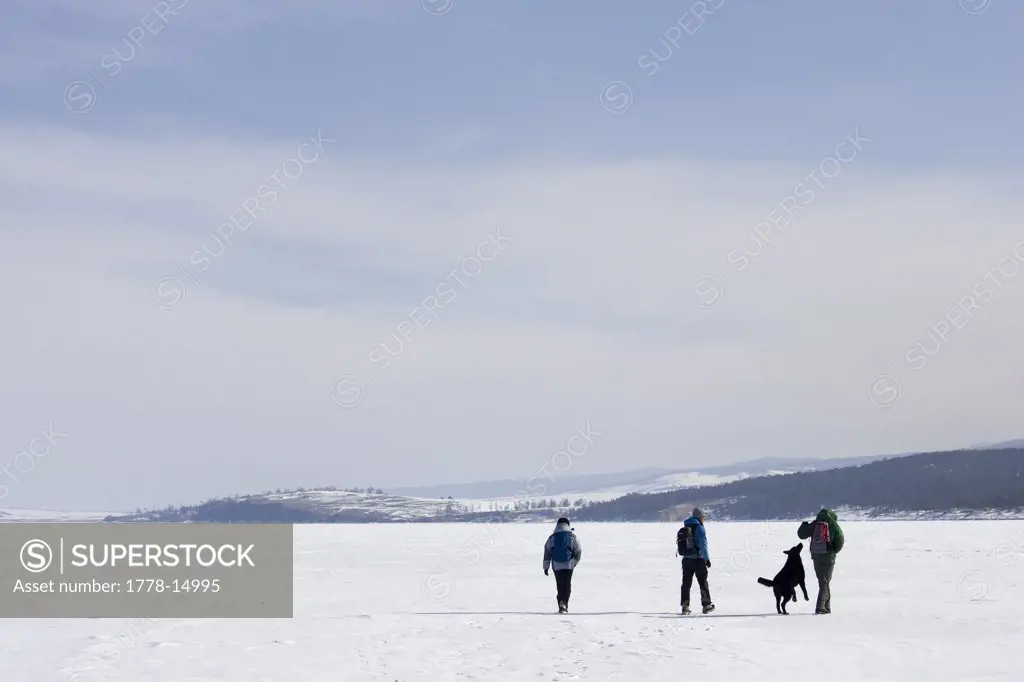 Hikers on the frozen Lake Baikal during the winter near Olkhon Island, Siberia, Russia