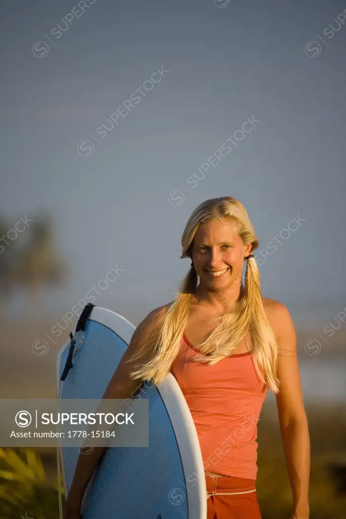 Portrait of young woman surfing in Mexico