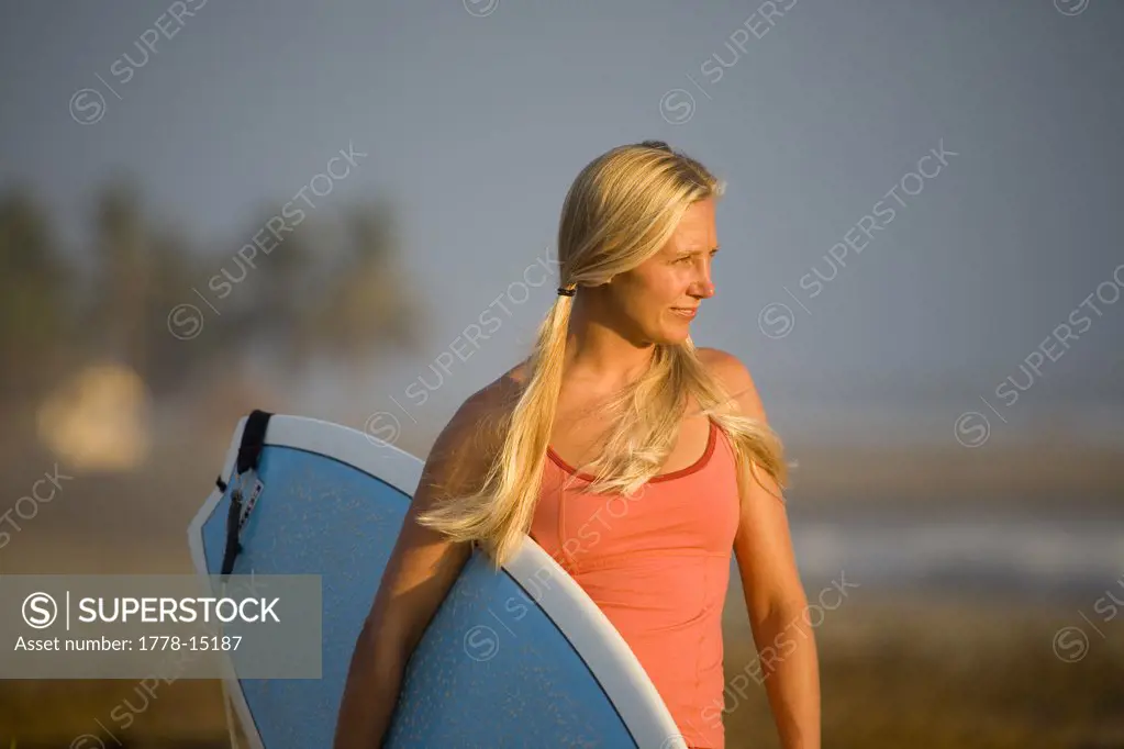 Portrait of young woman surfing in Mexico