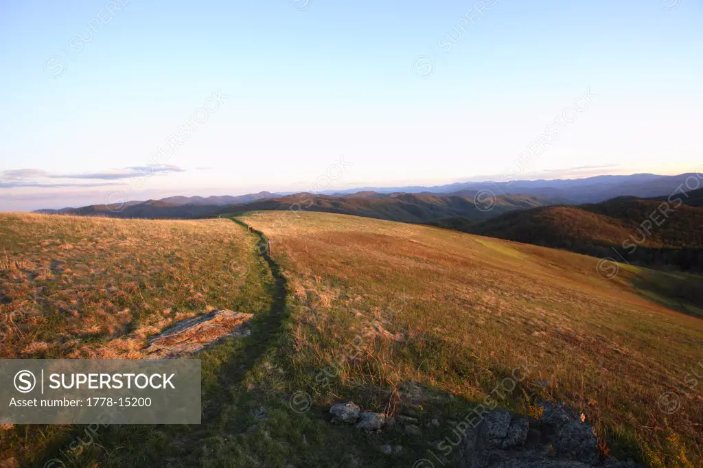 View down the final stretch of the Appalachian Trail to the summit of Max Patch Bald west of Asheville, NC at sunset