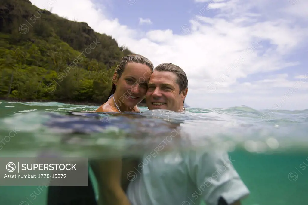A man and a woman swim at Ke'e Beach, Na Pali Coast, Kauai, Hawaii (water housing)