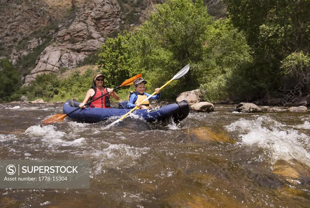 A mother and her son kayaking on the Cache La Poudre River, Fort Collins, Colorado