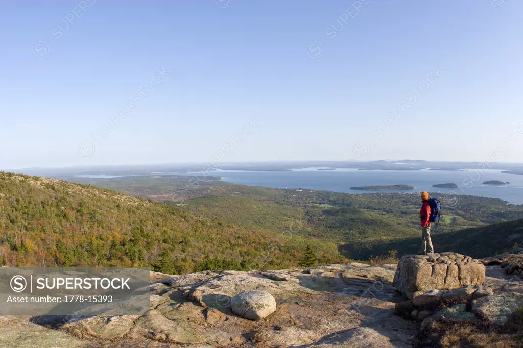 Young woman hiking on Cadillac Mountain in Acadia National Park Bar Harbor, Maine