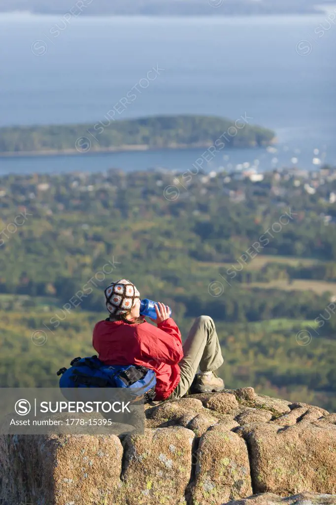 Young woman hiking on Cadillac Mountain in Acadia National Park Bar Harbor, Maine