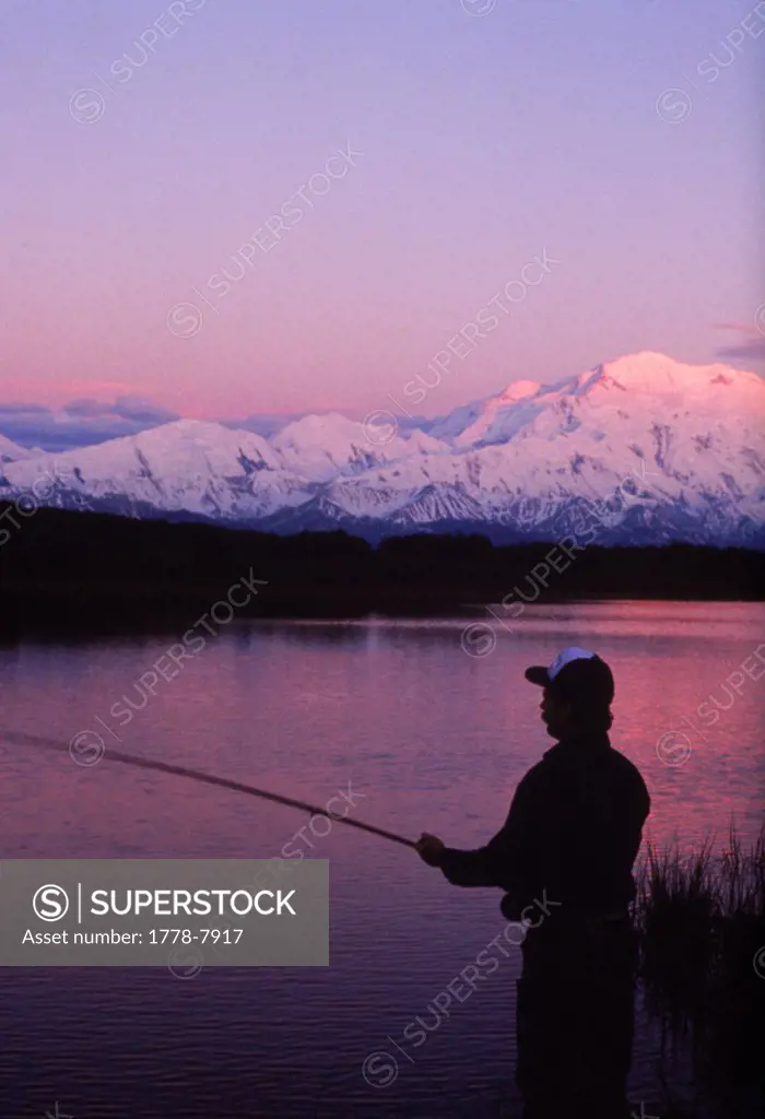 A fly fisherman tries his luck for trout and graying in a lake in Denali National Park