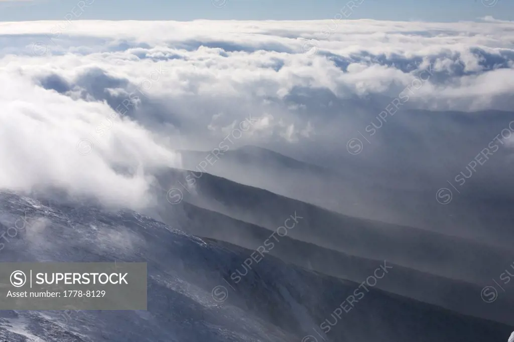 The snow covered slopes of Mt Washington in the White Mountains of New Hampshire surrounded by thick, swirling clouds