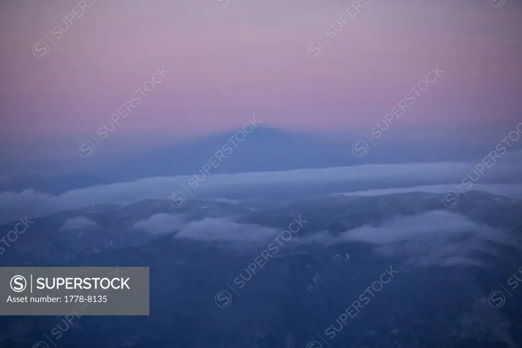 Fog rolls in across Mt Washington in the White Mountains of New Hampshire, beneath a purple sky