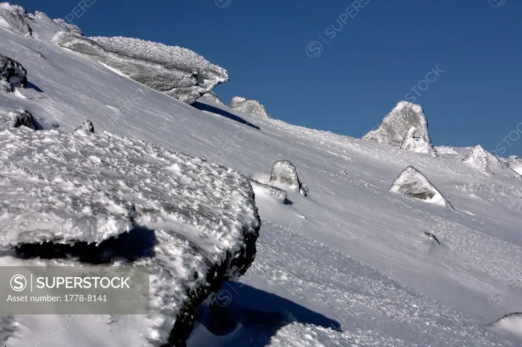 Jagged rocks on the snow covered slopes of Mt Washington in the White Mountains of New Hampshire