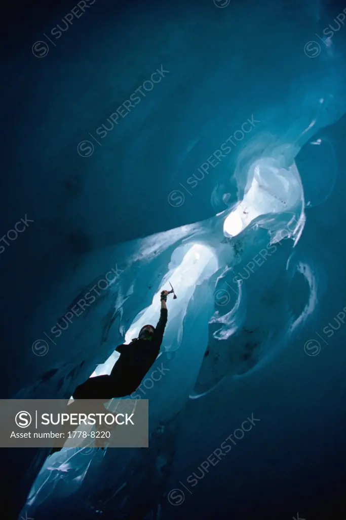 Ice climber climbs in an ice cave, Franz Josef Glacier, South Island, New Zealand