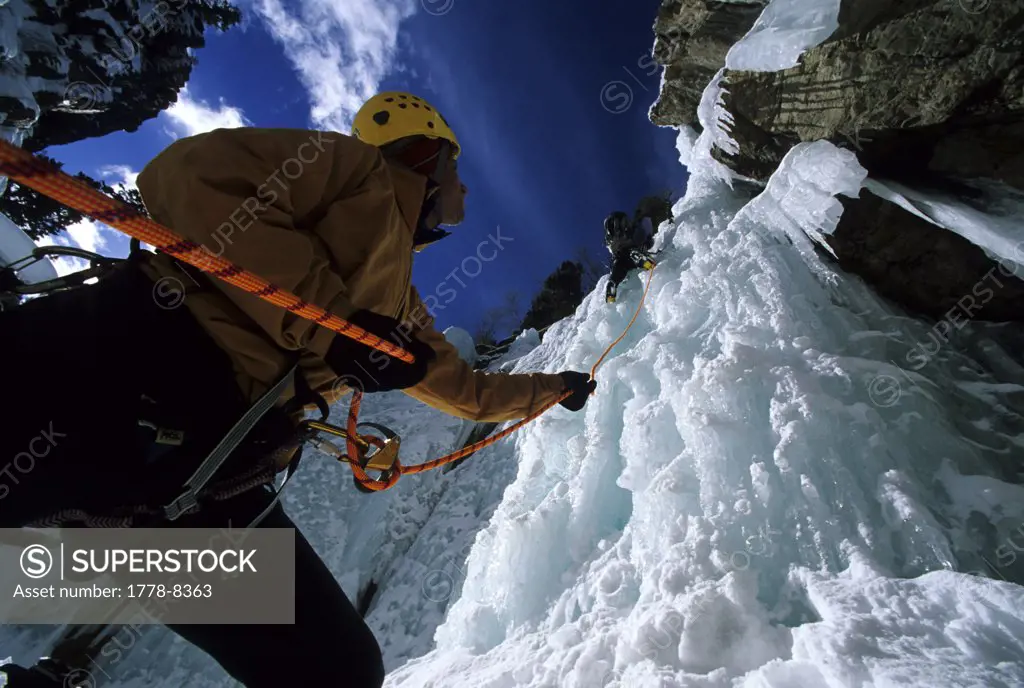 Belaying an ice climber, Colorado