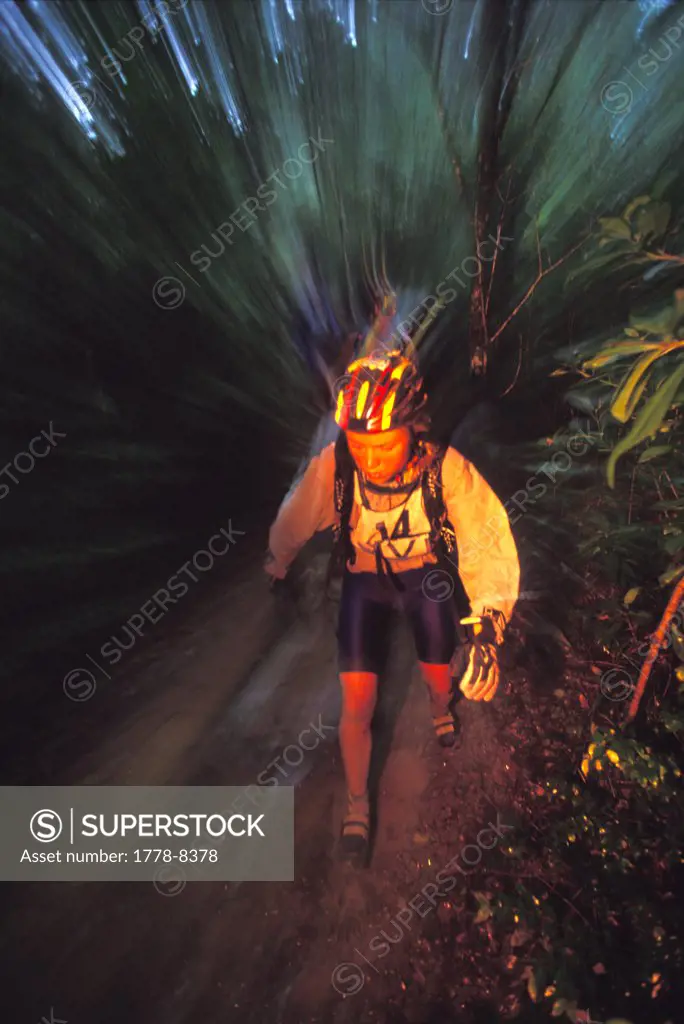 Woman hiking through jungle during the 2001 Expedition BVI in the British Virgin Islands (flash effects, blurred motion)