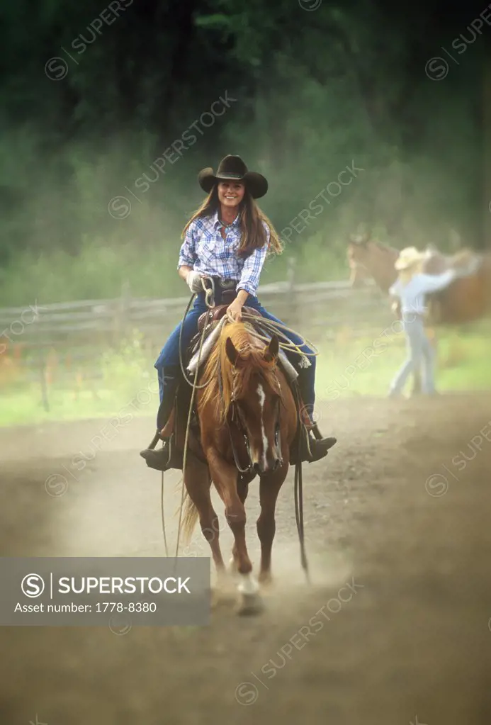 Cowgirl on horse with lariat, Colorado