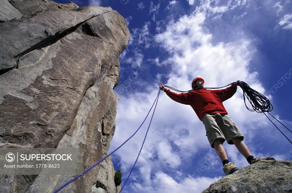 Boy coiling rock climbing rope at City Of Rocks, Idaho