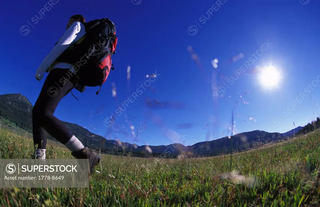 Woman hikes - backpacks in Hope Valley, California