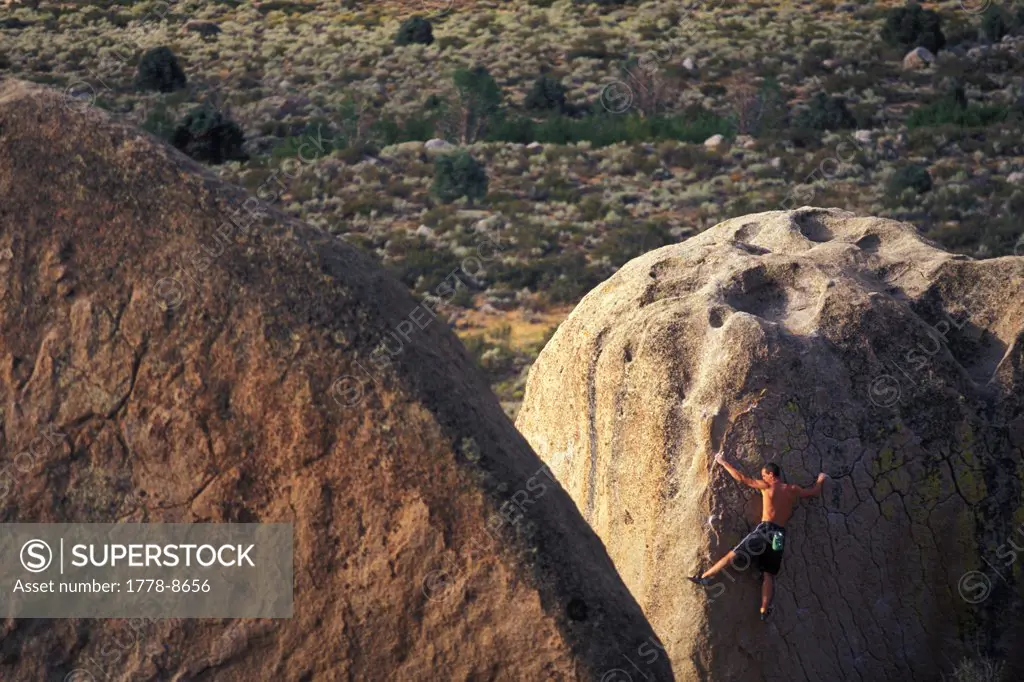Man rock climbing - bouldering at the Buttermilk boulders near Bishop, California