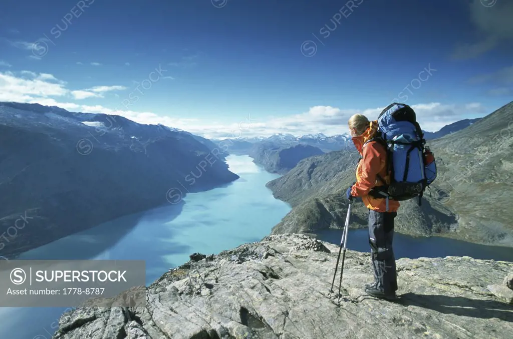 A woman backpacking in Jotunheimen National Park, looking over lake Norway