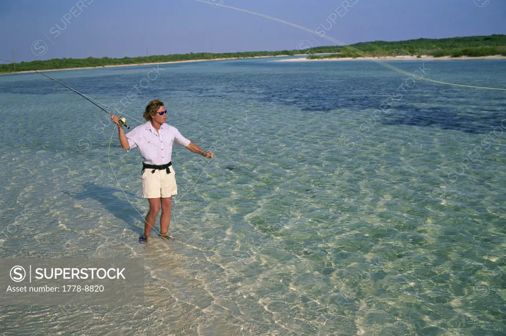 A fly-fisherman casts to a bonefish in the Bahamas