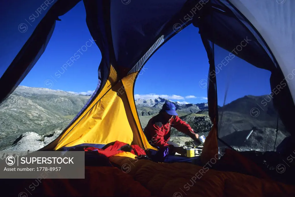 A climber prepares a meal, Sierra Santa Marta Mountains, Colombia