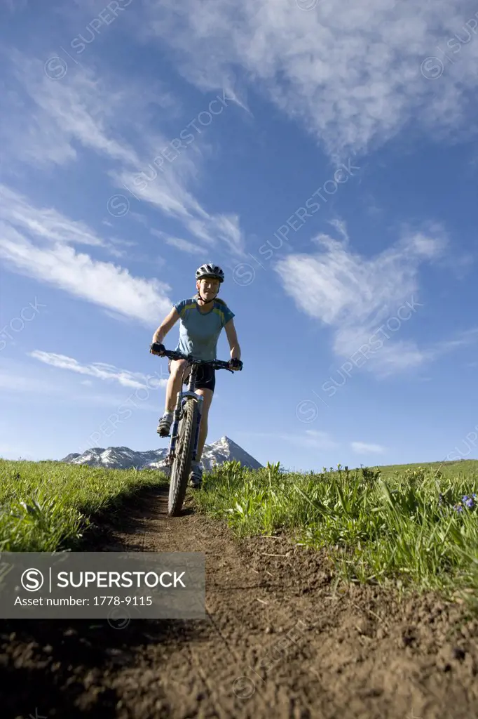 Woman riding mountain bike, Colorado