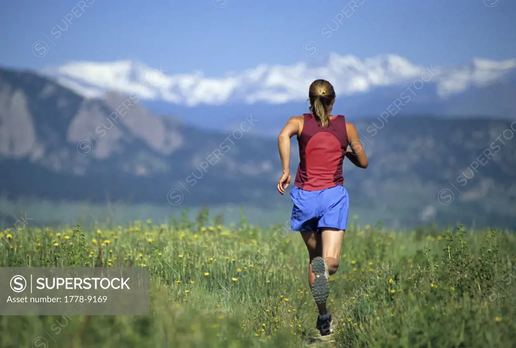 A woman trail running near Boulder, CO