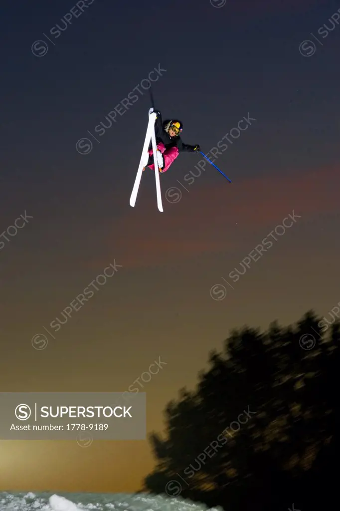Skier jumps at sunset