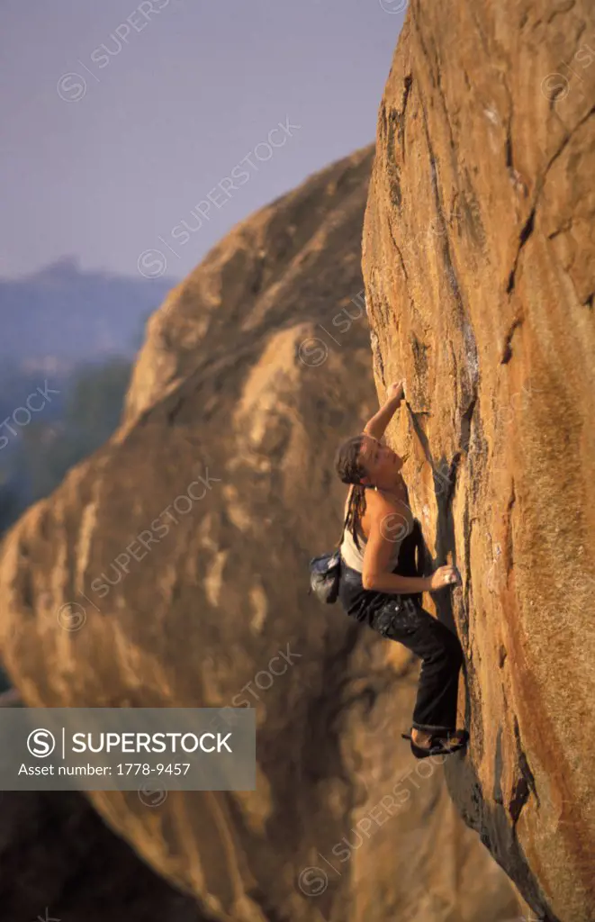 Woman bouldering on desert rock