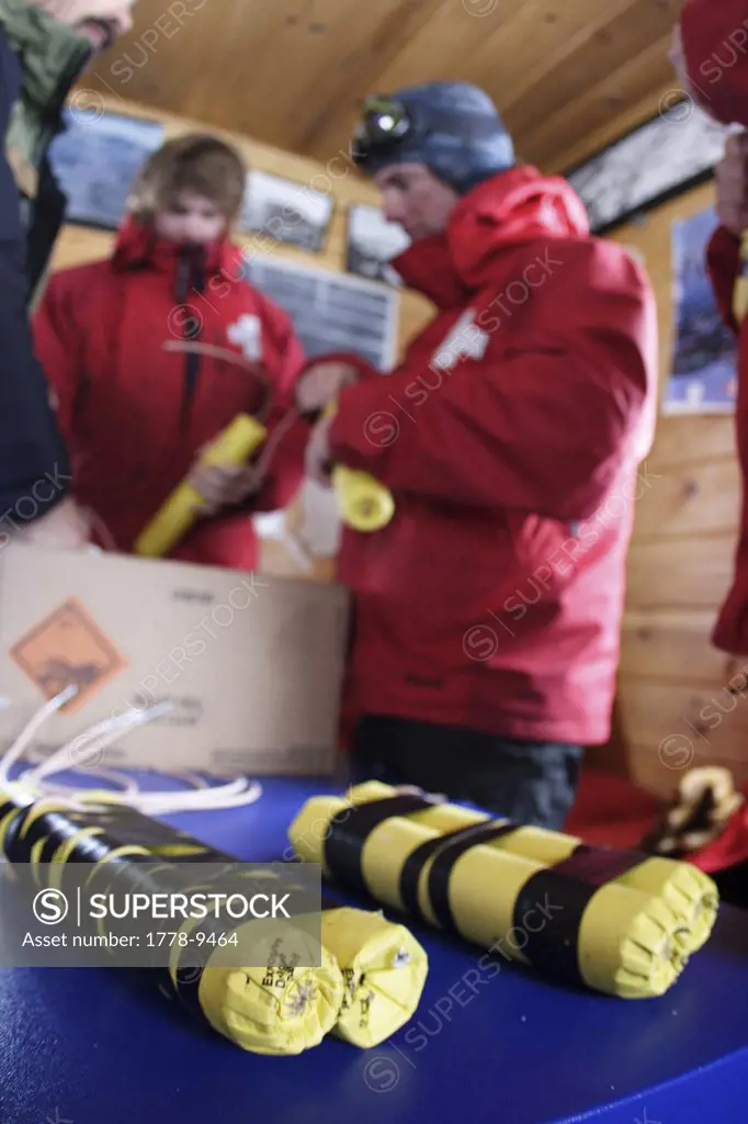 Ski patrollers prepare dynamite for the day's snow safety route Ski patrollers throw dynamite to trigger potential avalanches b
