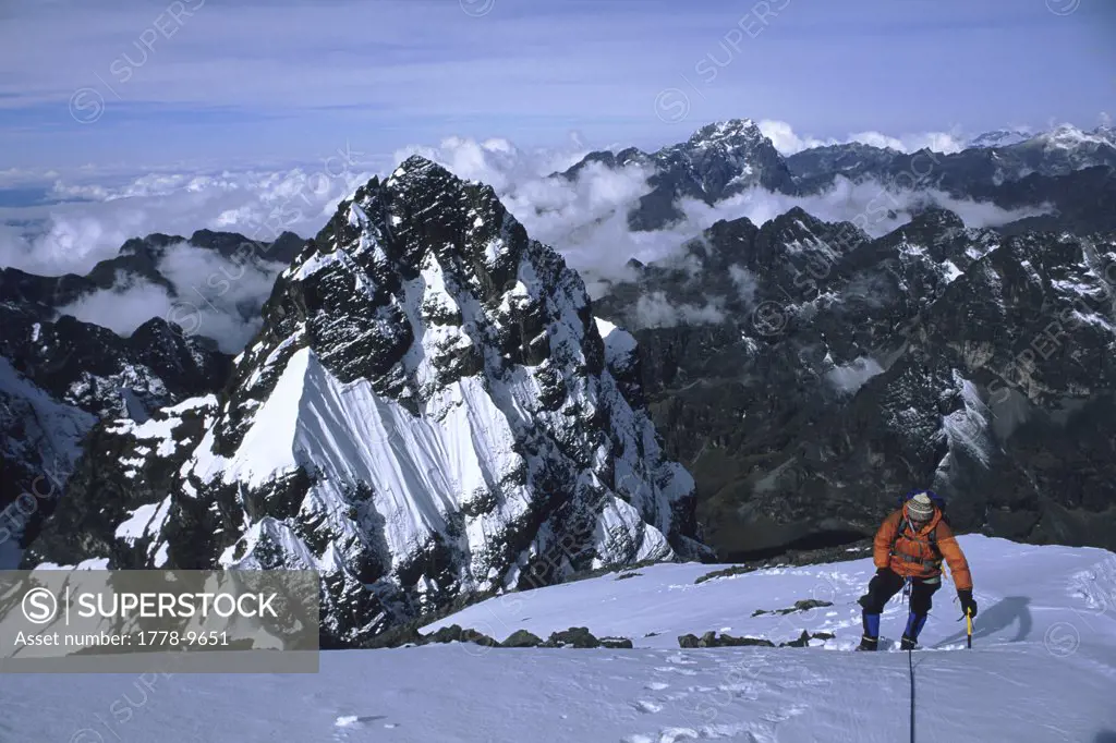 A mountain climber approaches the summit of Pequeno Alpamayo, Cordillera Real, Bolivia