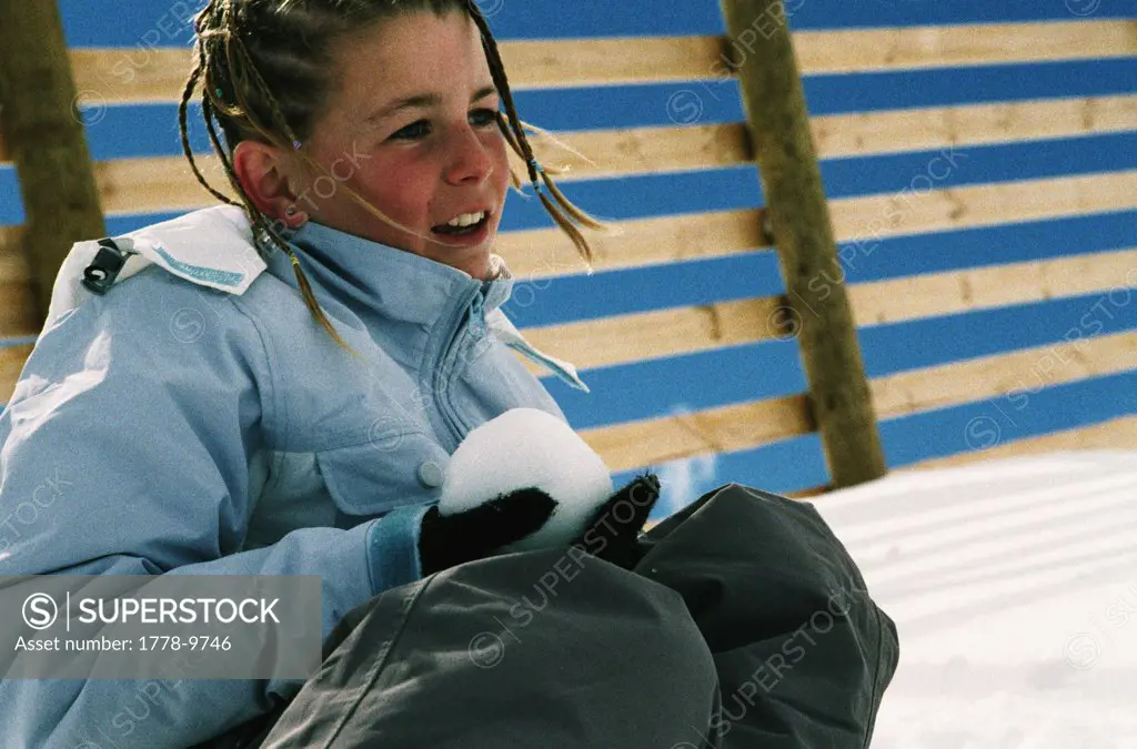 Girl with snowball at ski resort