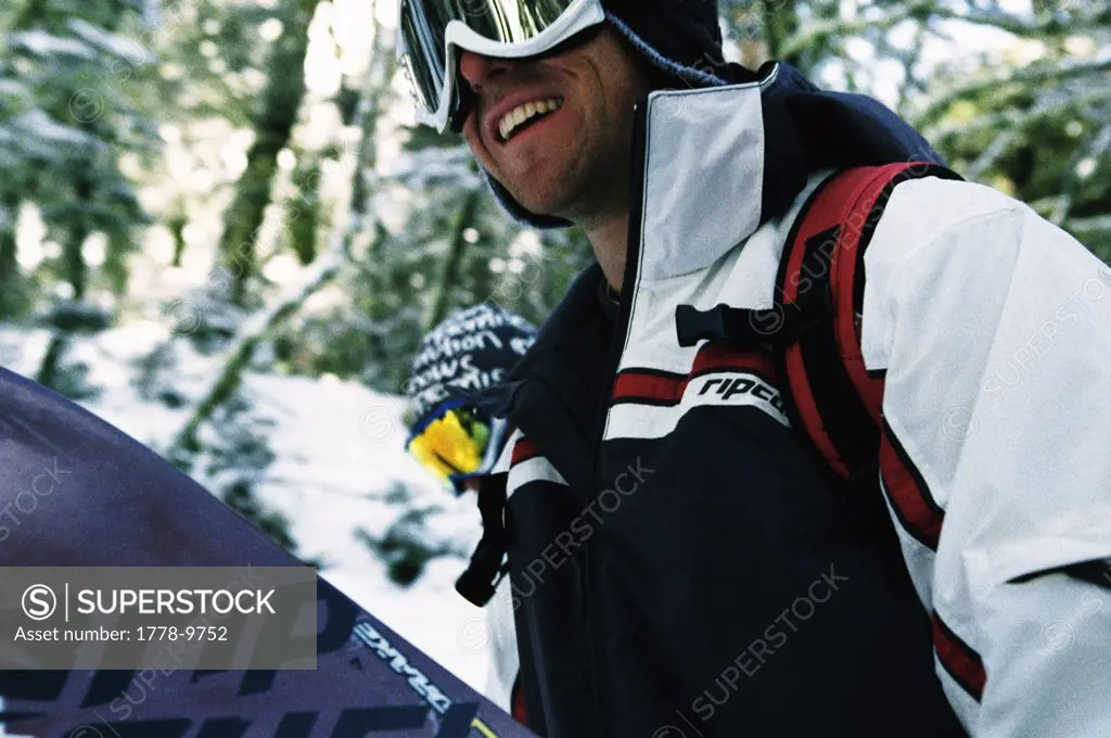 Snowboarder hiking through trees (Grainy)