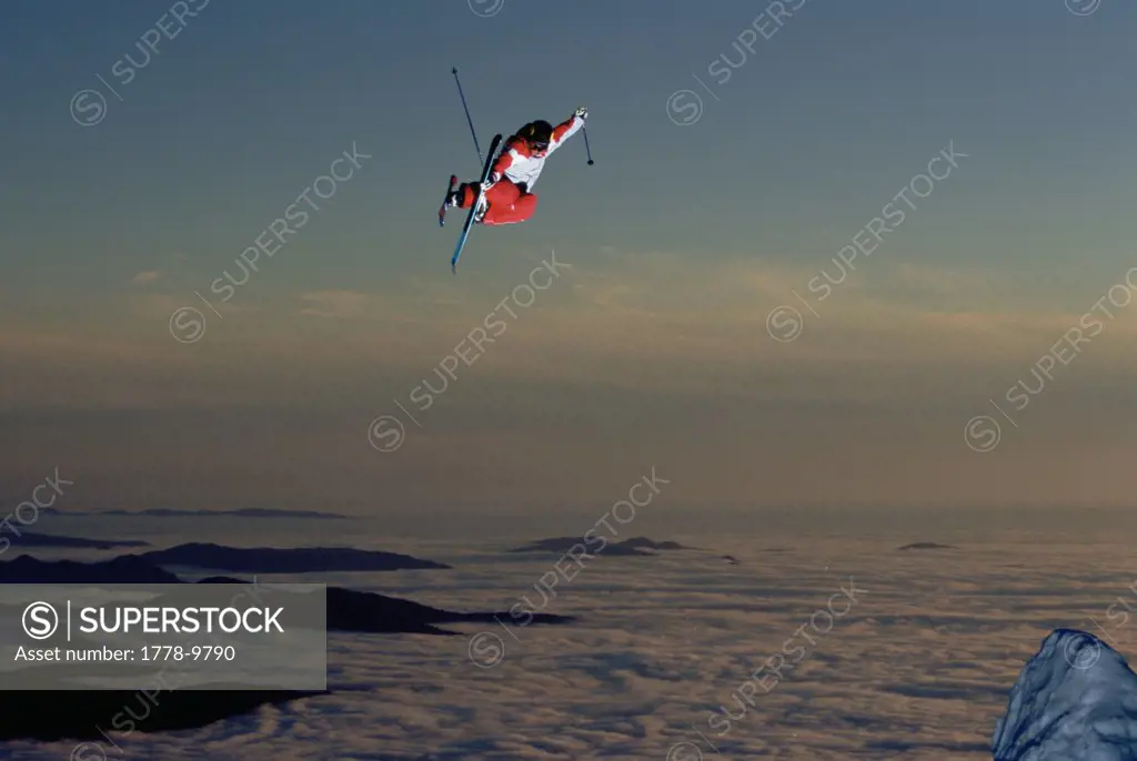 A skier jumps high into the air