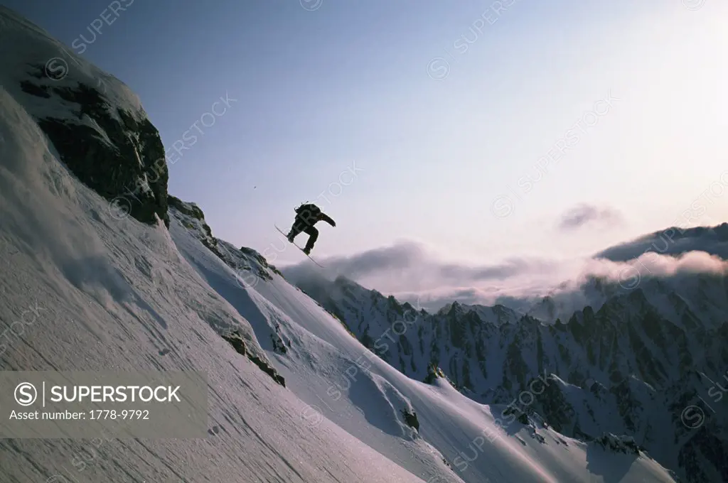 Cliff jump on snowboard