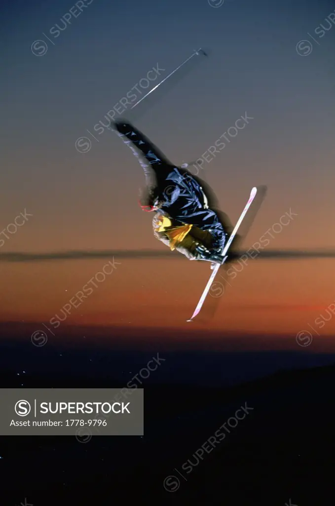 Skier catches air at sunset